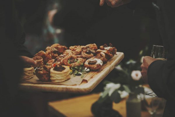 Delicious canapes being served on a wooden platter by Kerra's Catering as featured on eeek! weddings