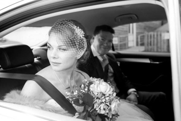 A photograph of a bride looking out of the car window on her way to get married, natural reportage style of photography