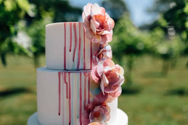White drip cake with edible flowers